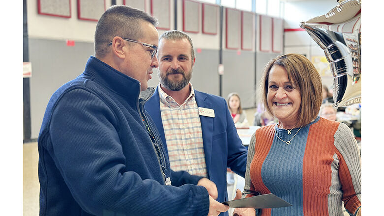 Fox C-6 School District Superintendent Paul Fregeau, left, presents Karen Jansen, a special education paraprofessional at Meramec Heights Elementary School, with Fox’s support staff member of the year award.